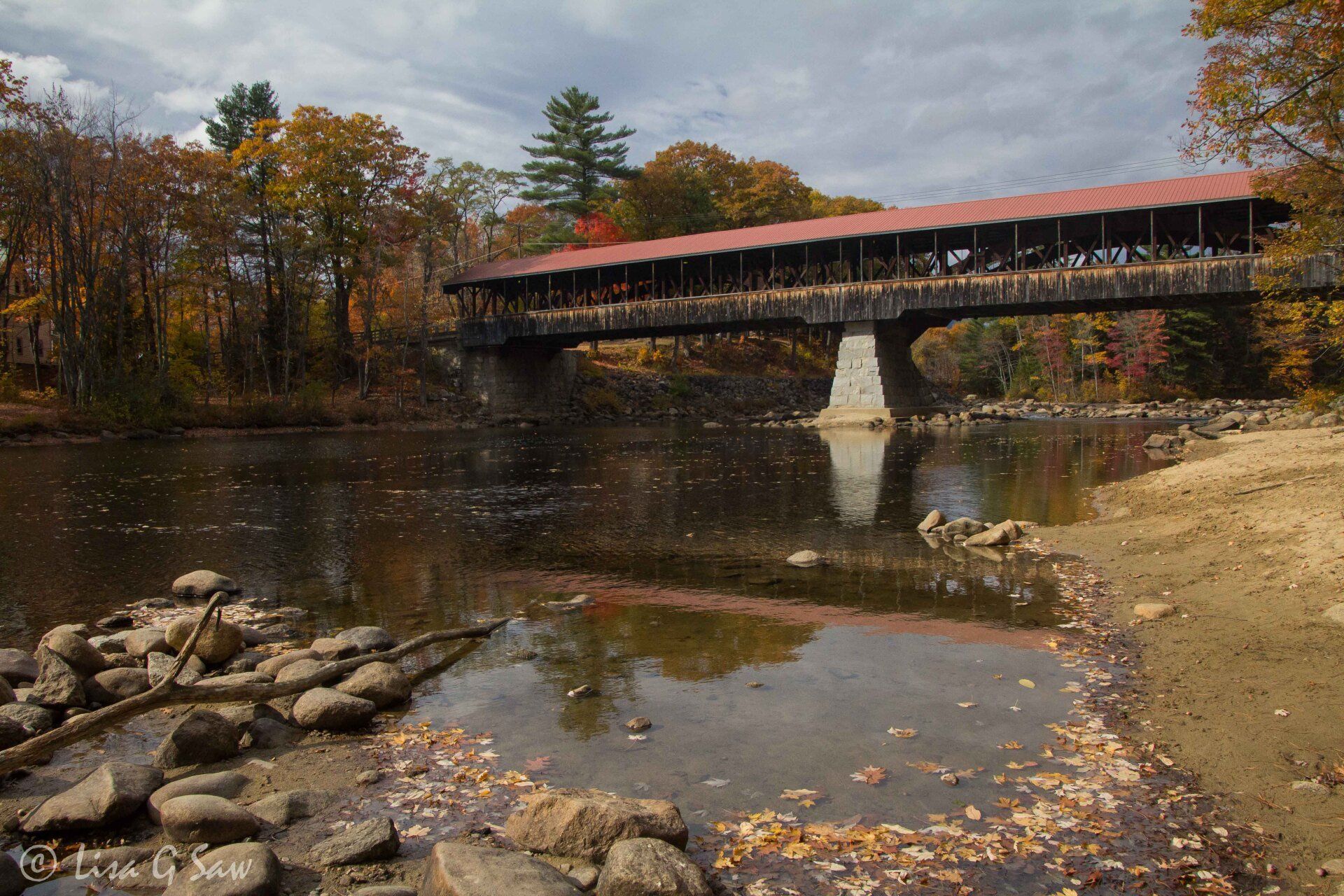 Red covered bridge and river