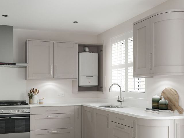 Kitchen with cabinets, sink, stove, and a wall-mounted boiler unit.