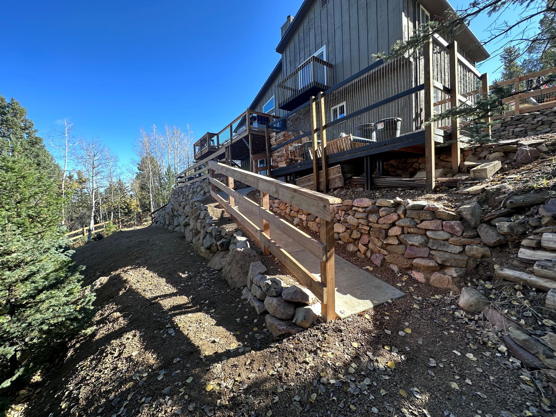 A wooden staircase leading up to a house on a hill