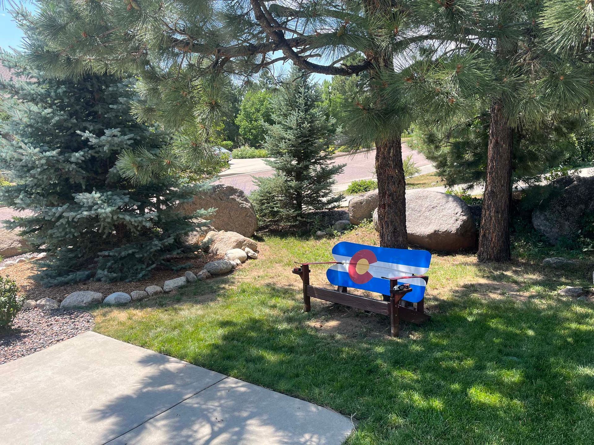 A park bench with a colorado flag painted on it