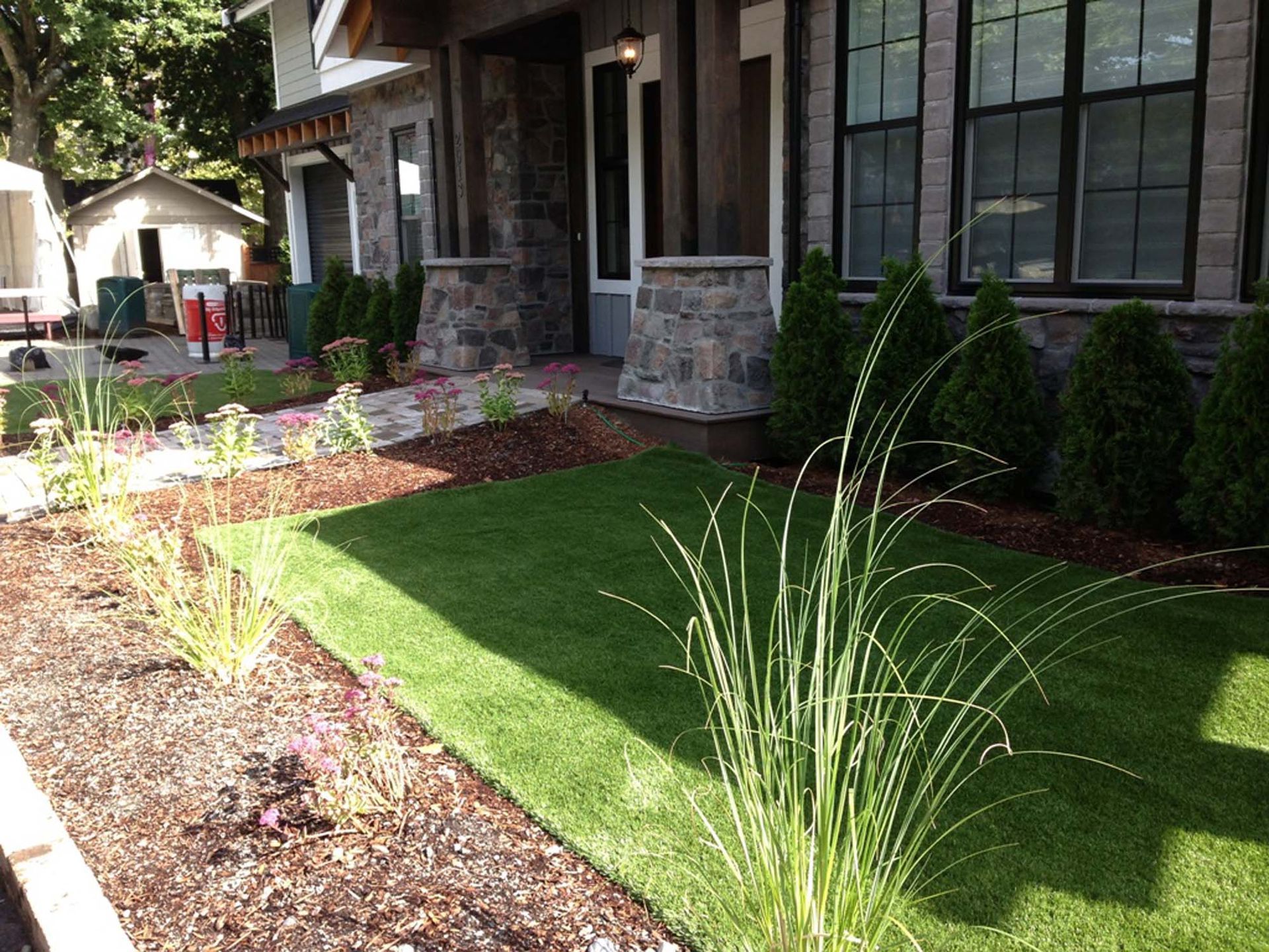 A house with a lush green lawn in front of it