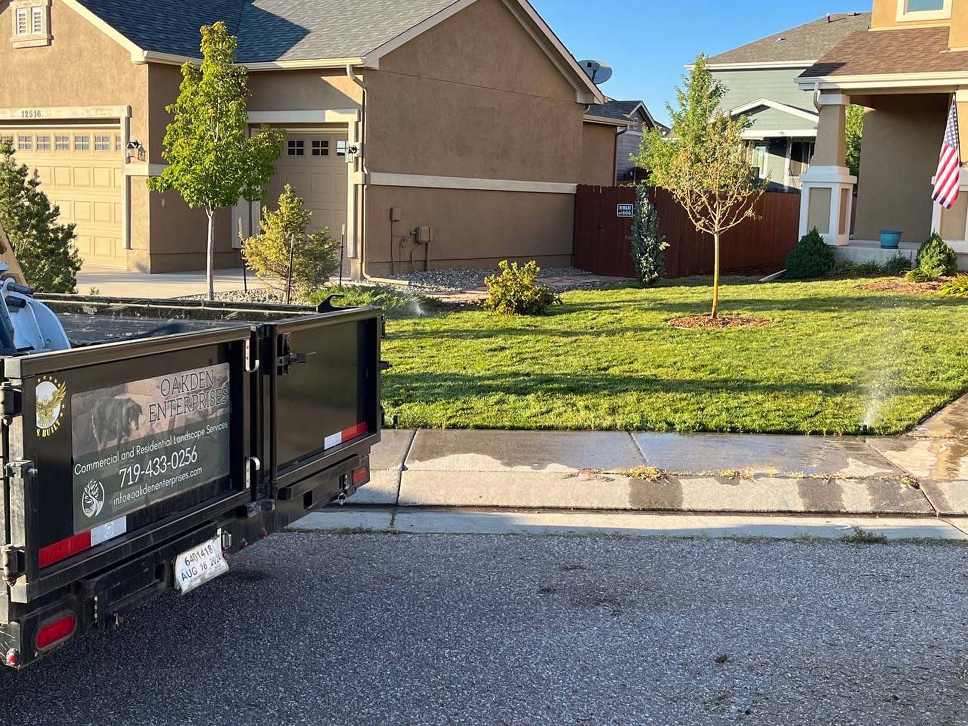 A dumpster is parked in front of a house