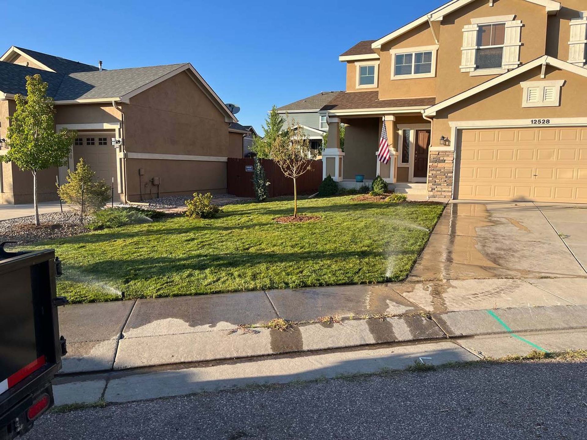 A house with a sprinkler in front of it