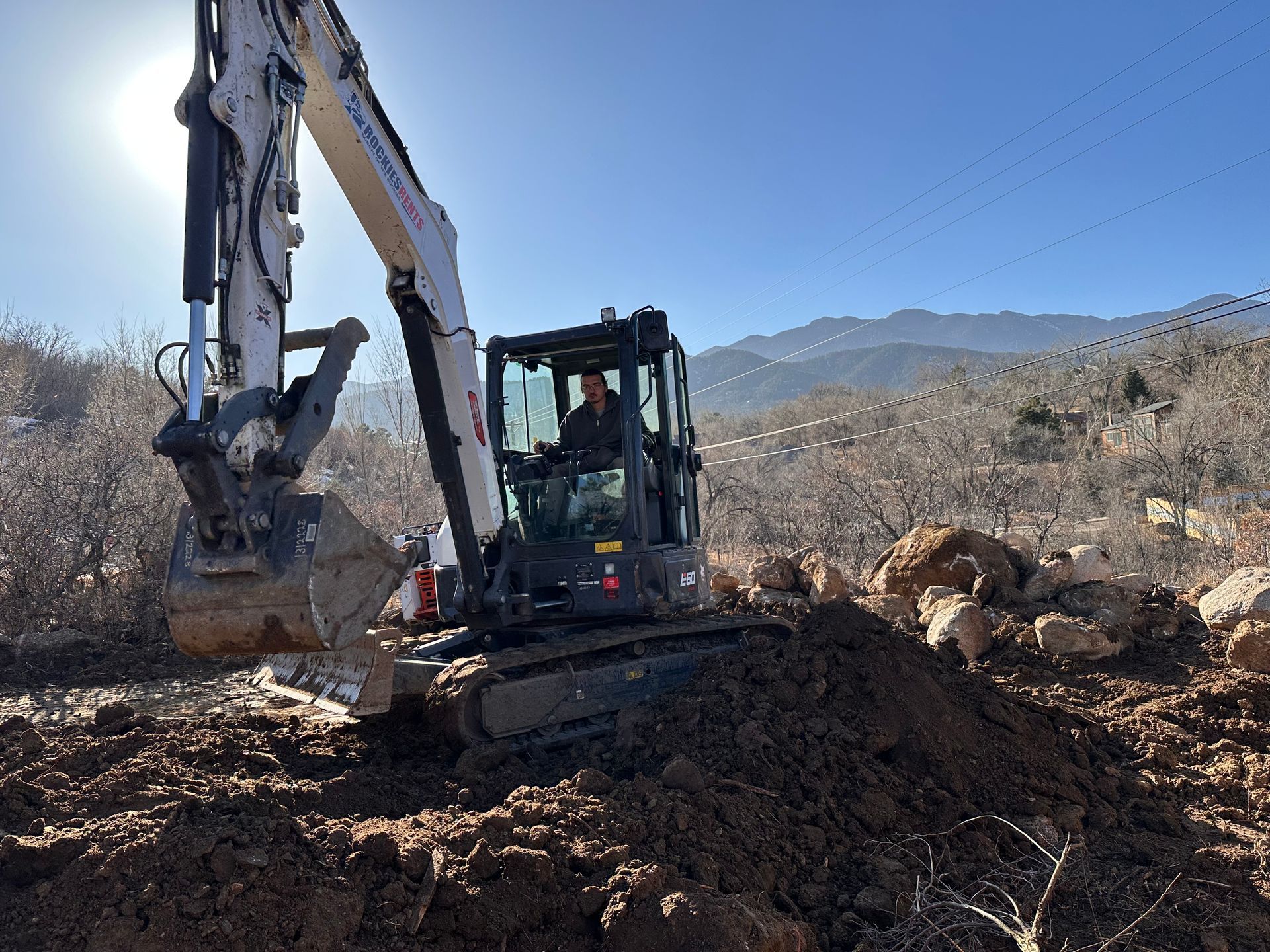 A bulldozer is digging a hole in the dirt