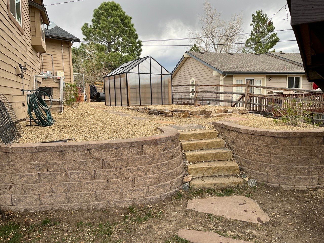 A house with a greenhouse in the backyard