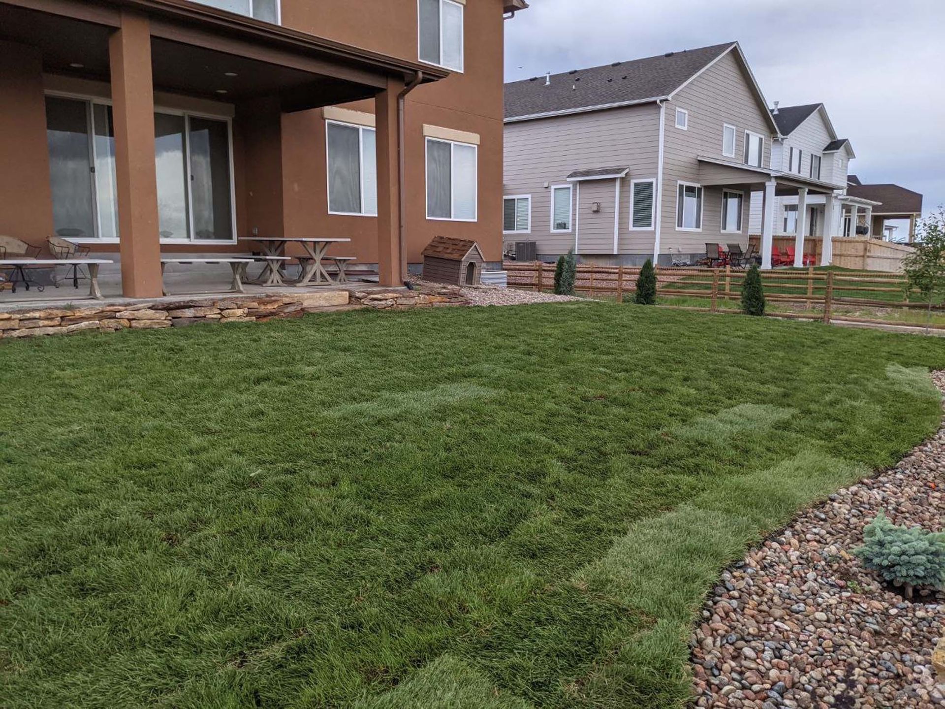 A house with a large lawn in front of it