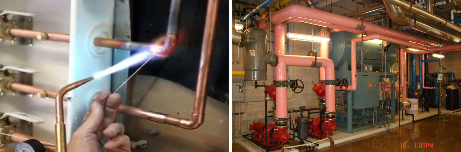 Worker soldering copper pipes in a mechanical room with boilers and red piping