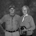 A man and a woman are standing next to each other in a black and white photo.