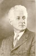A black and white photo of a man in a suit and tie.