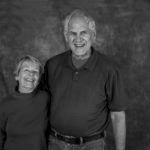 A man and a woman are posing for a black and white photo.