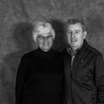 A black and white photo of a man and a woman posing for a picture.