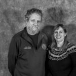 A man and a woman are posing for a picture together in a black and white photo.