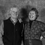 A man and a woman are posing for a black and white photo.