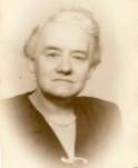 A black and white photo of an older woman in a black jacket.