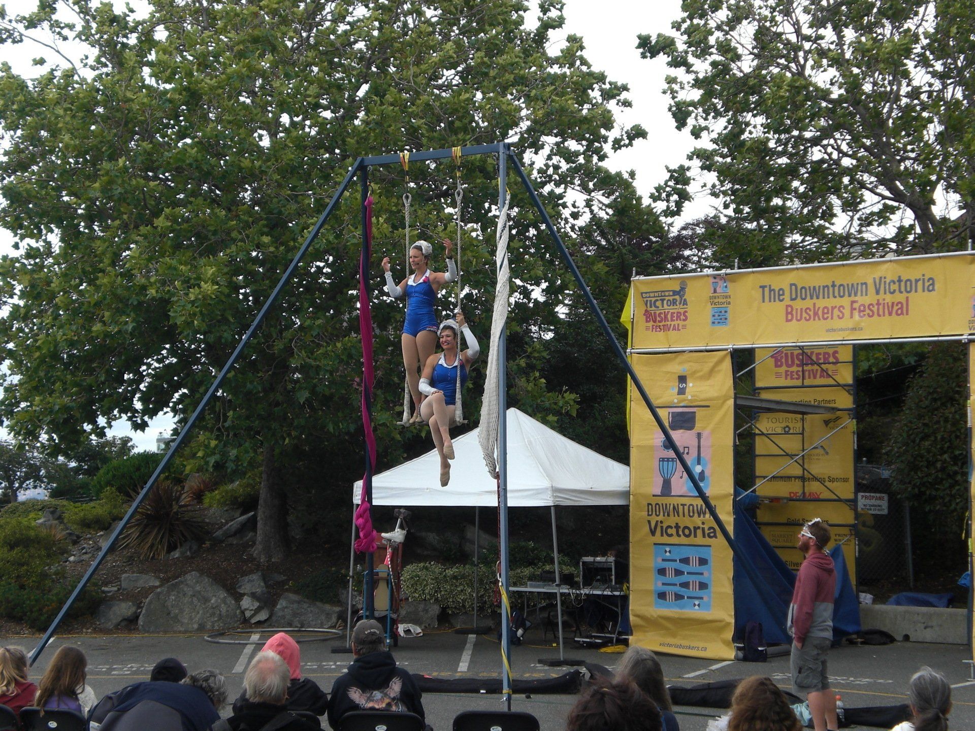 Two acrobats on a trapeze perform at a festival in Victoria, BC.