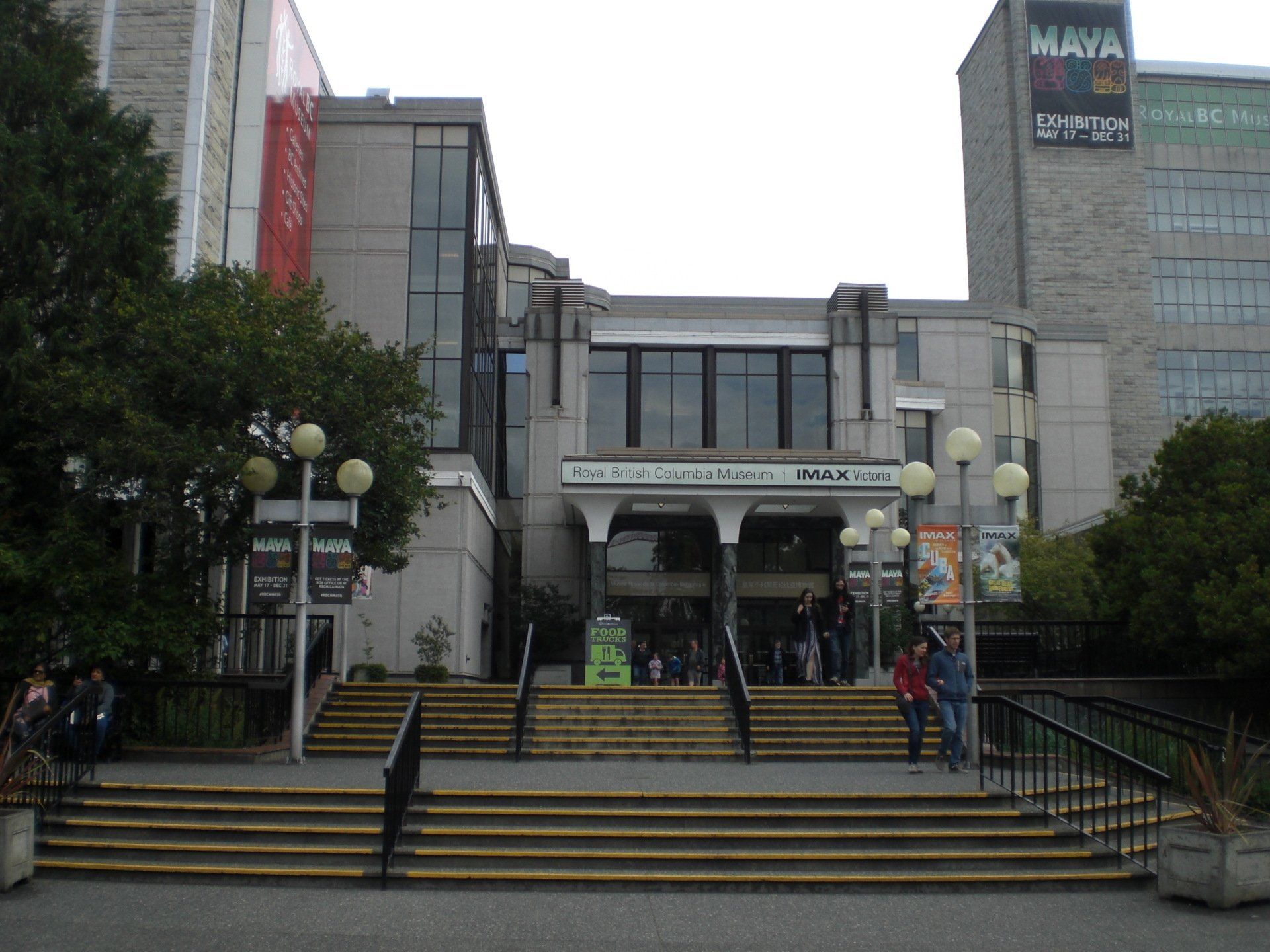 Entrance to Museum of Anthropology with steps, concrete exterior, people, and signs.