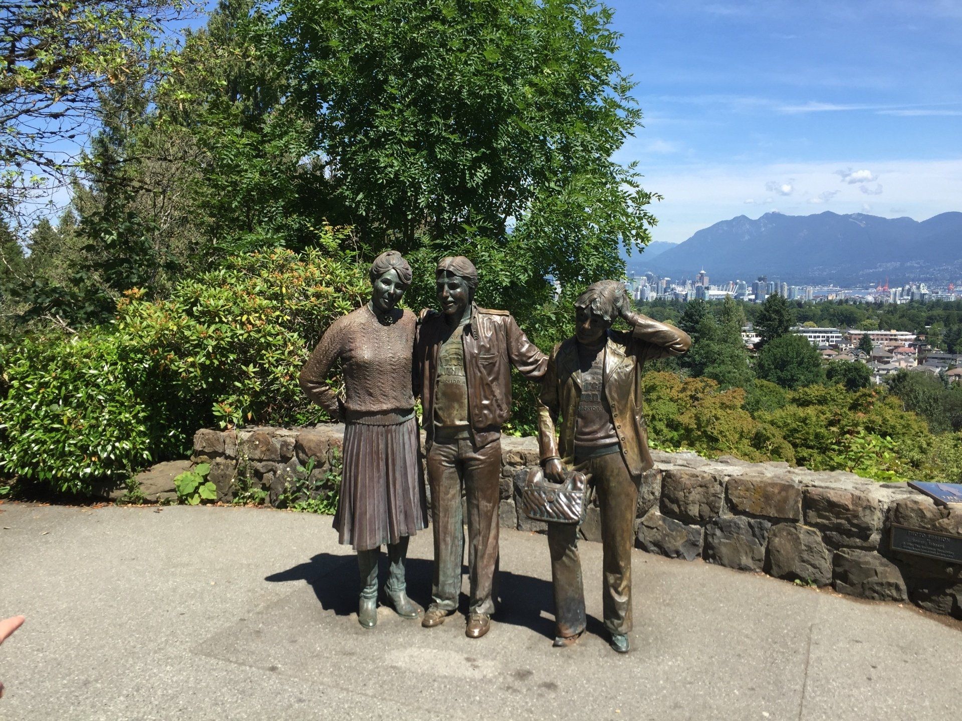 Bronze statue of three people overlooking Vancouver