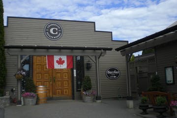 Entrance to a building with a Canadian flag and a sign reading 