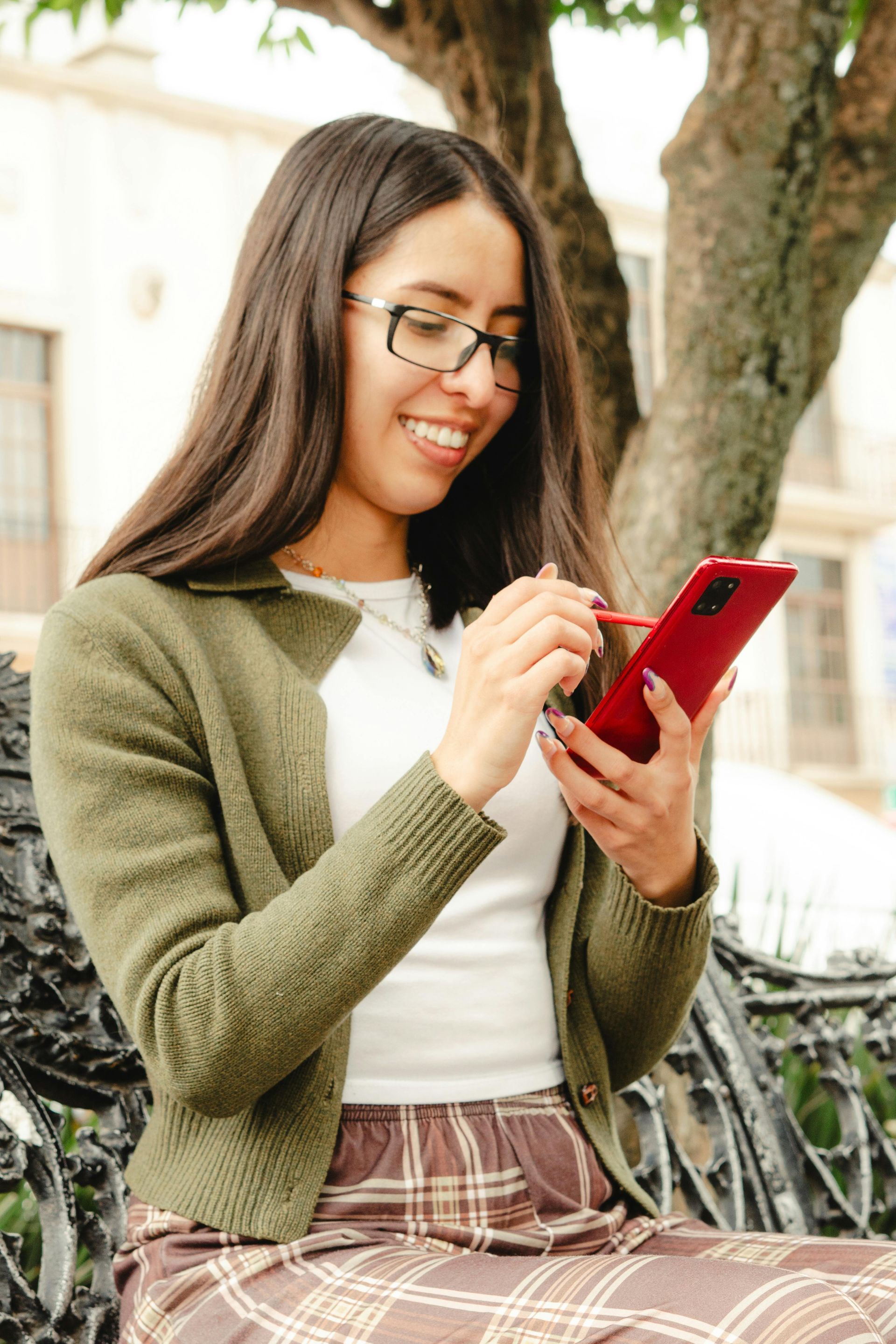 A woman is holding a credit card and a cell phone.