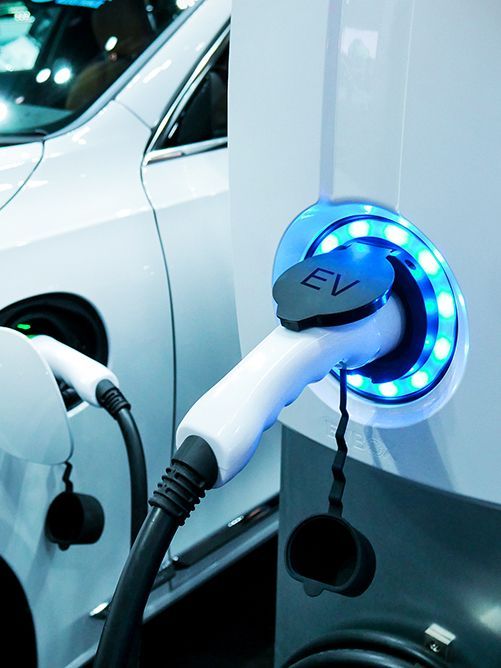An electric car is being charged at an EV charging station