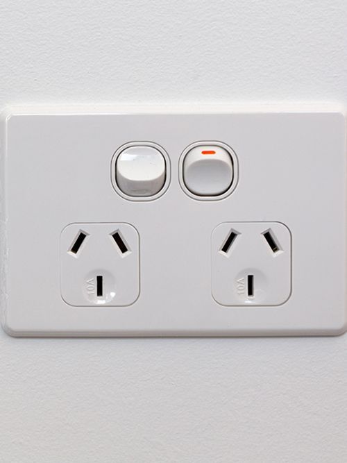 A white electrical outlet with two switches on it