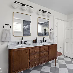 Double bathroom vanity with marble countertop and modern lighting – remodeling contractor project.