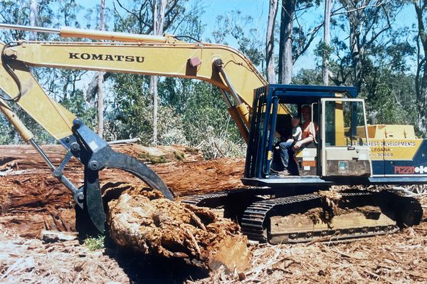 Robert Kerrison in digger with his son Dwayne on his knee.
