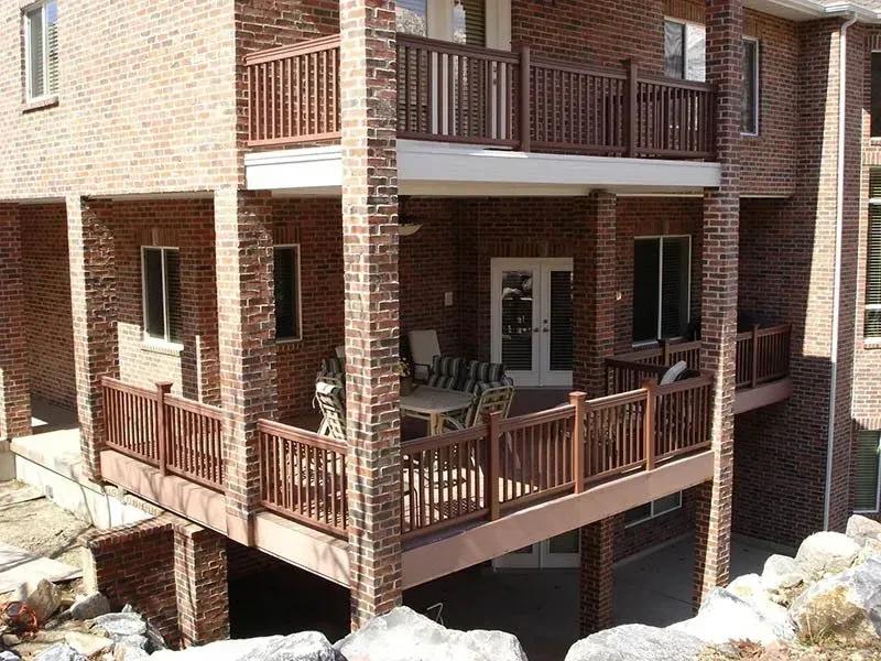 Brick apartment balconies with wooden railings and shaded walkways
