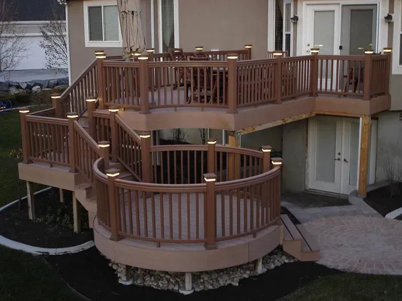 Wooden multi-level deck and ramp outside a beige house