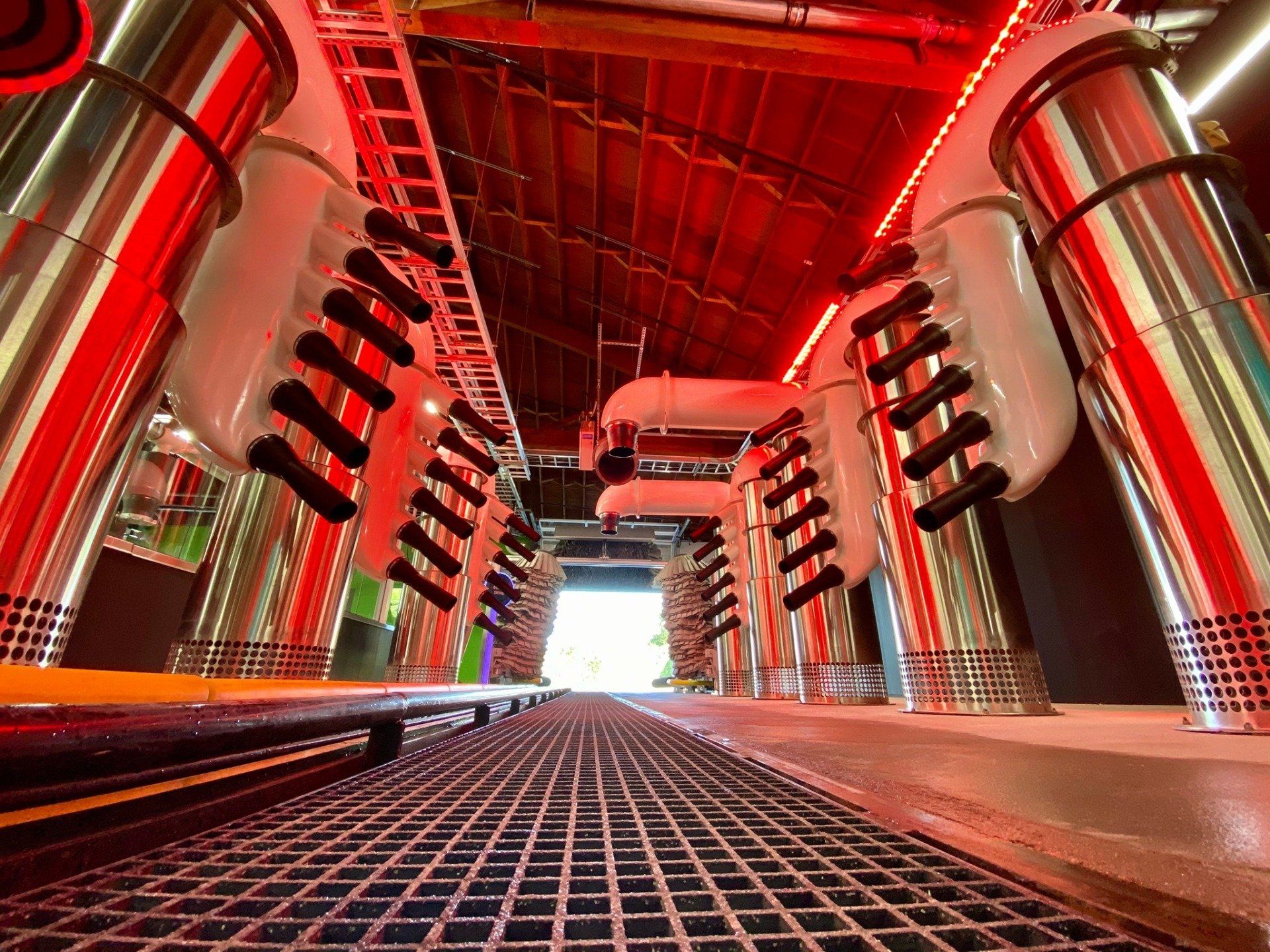 inside of a red car wash with dryers