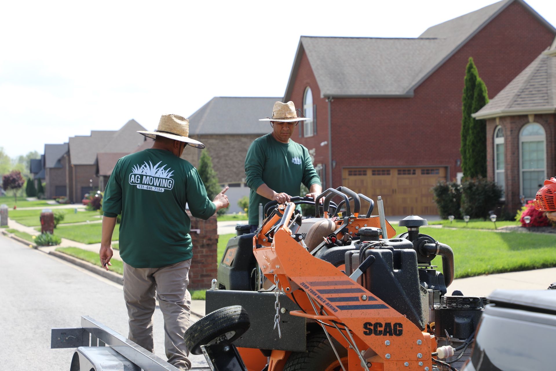 Two men standing next to a tractor