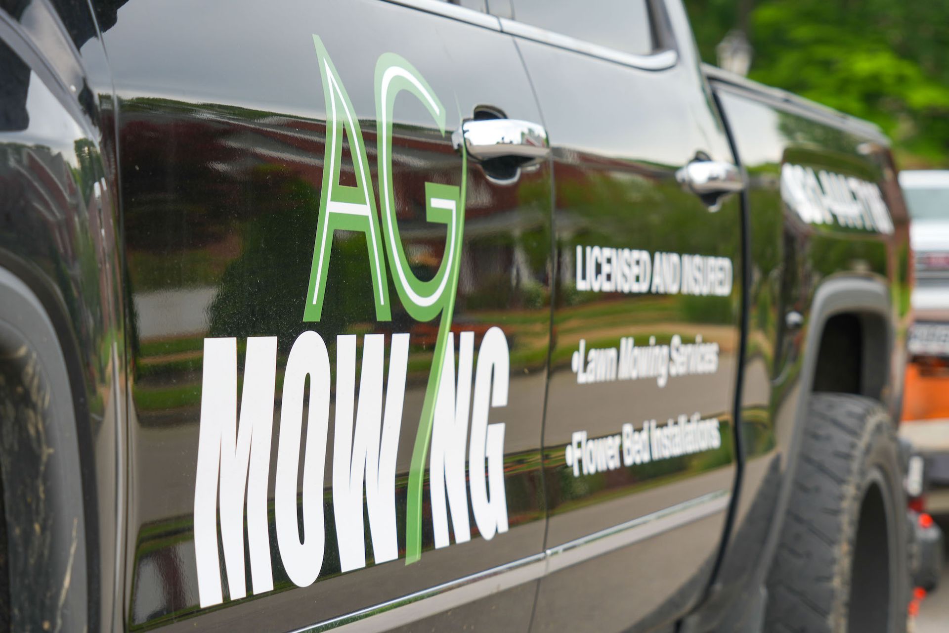 A black truck that says ag mowing on the side
