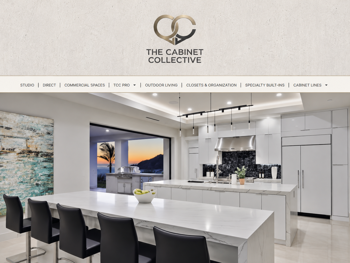 Modern white kitchen with marble island, black bar stools, and large windows at sunset