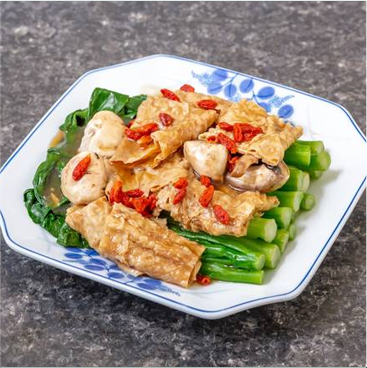 Plate of steamed tofu, mushrooms, green vegetables, and goji berries.