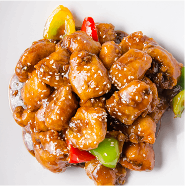 Sweet and sour chicken with sesame seeds, colorful bell peppers, and a brown sauce on a white plate.