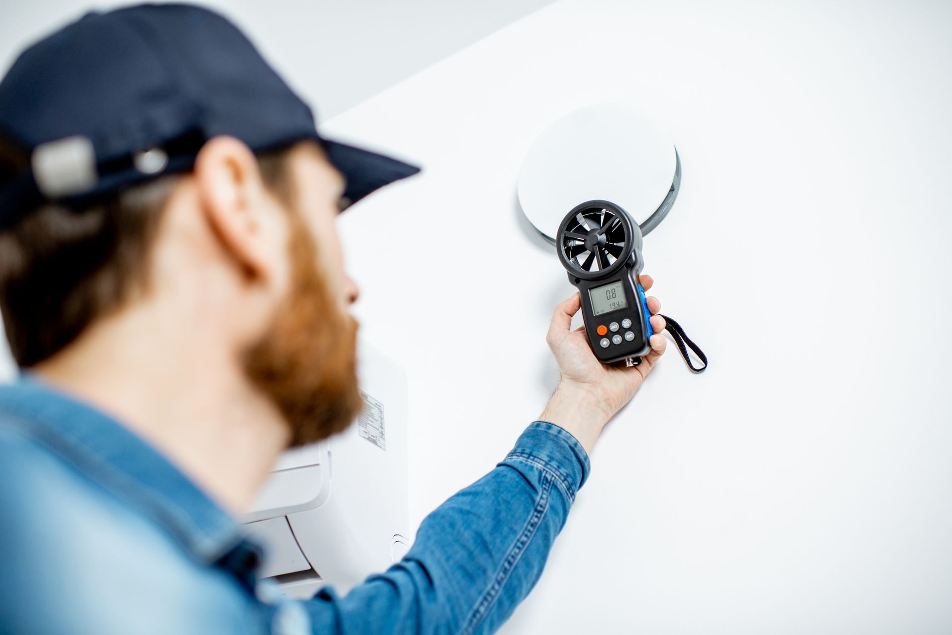 Handyman conducting an indoor air quality test in Phoenix, AZ, ensuring healthy air for homes and fa