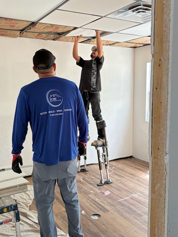 Acme Restoration technicians repairing a damaged ceiling after property damage