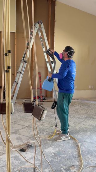 Acme Restoration technician fogging a damaged property during restoration work