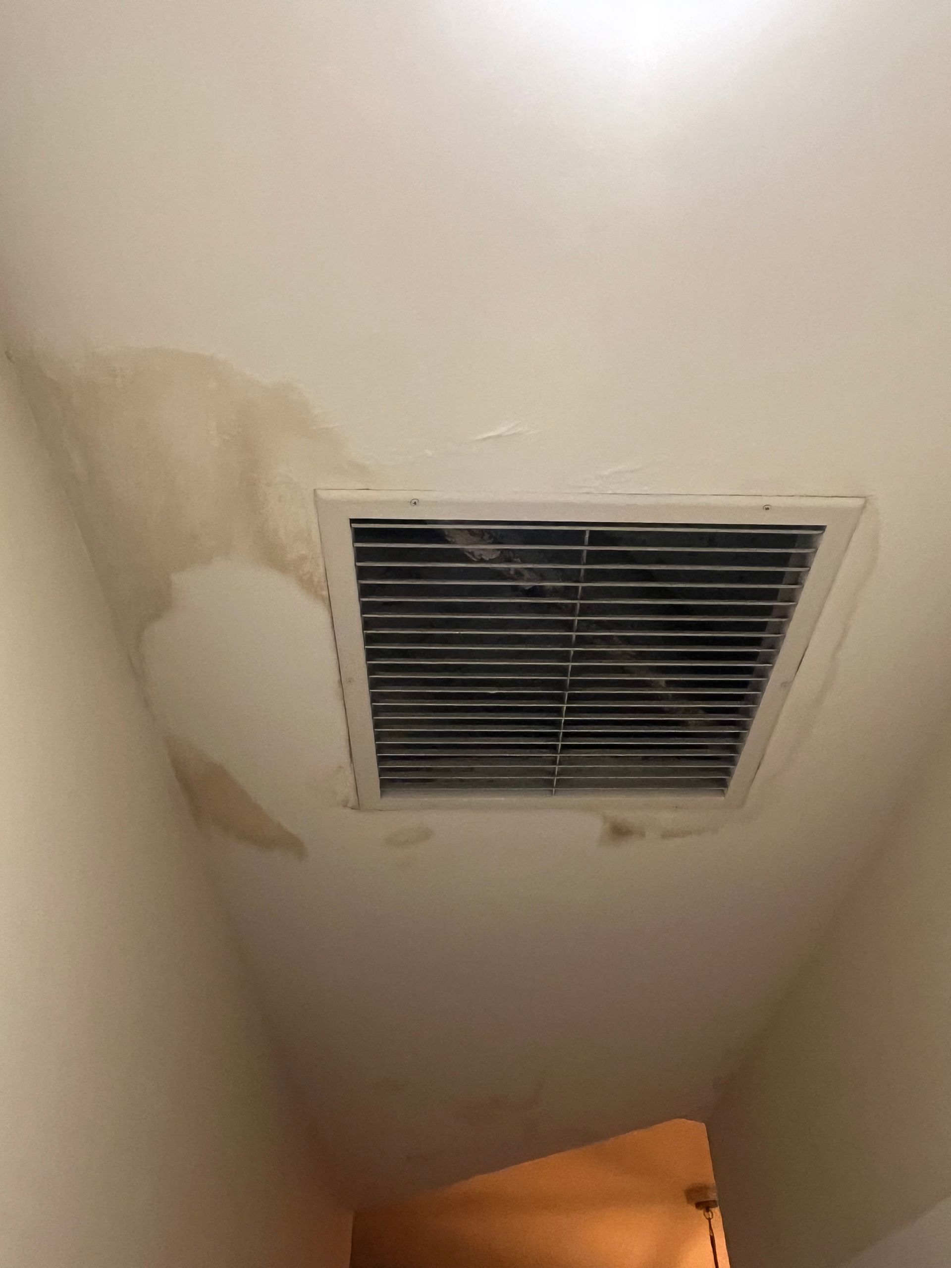 Water-damaged ceiling around an AC vent after an air-conditioning system failure on Siesta Key
