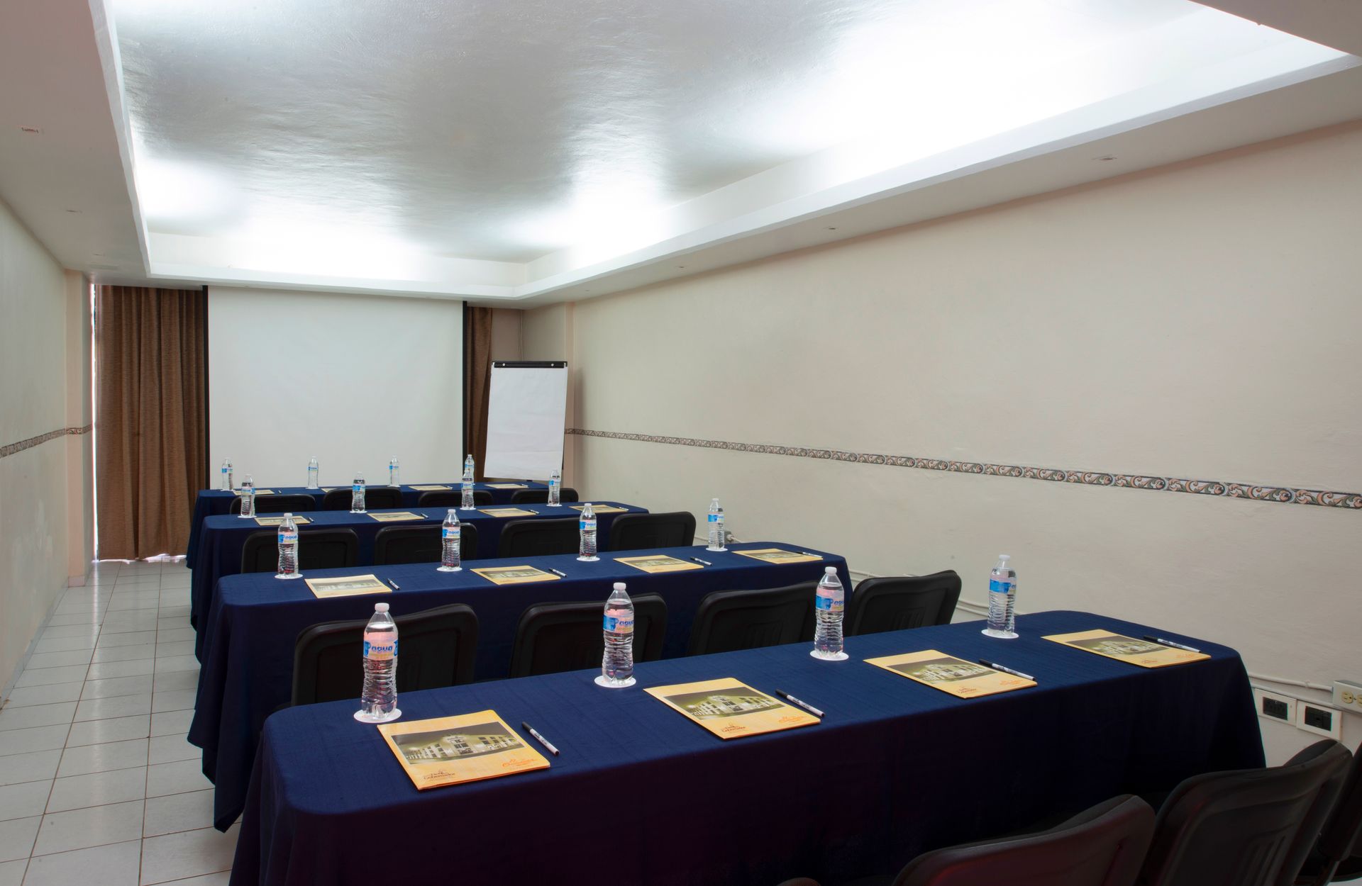 A conference room with tables and chairs set up for a meeting