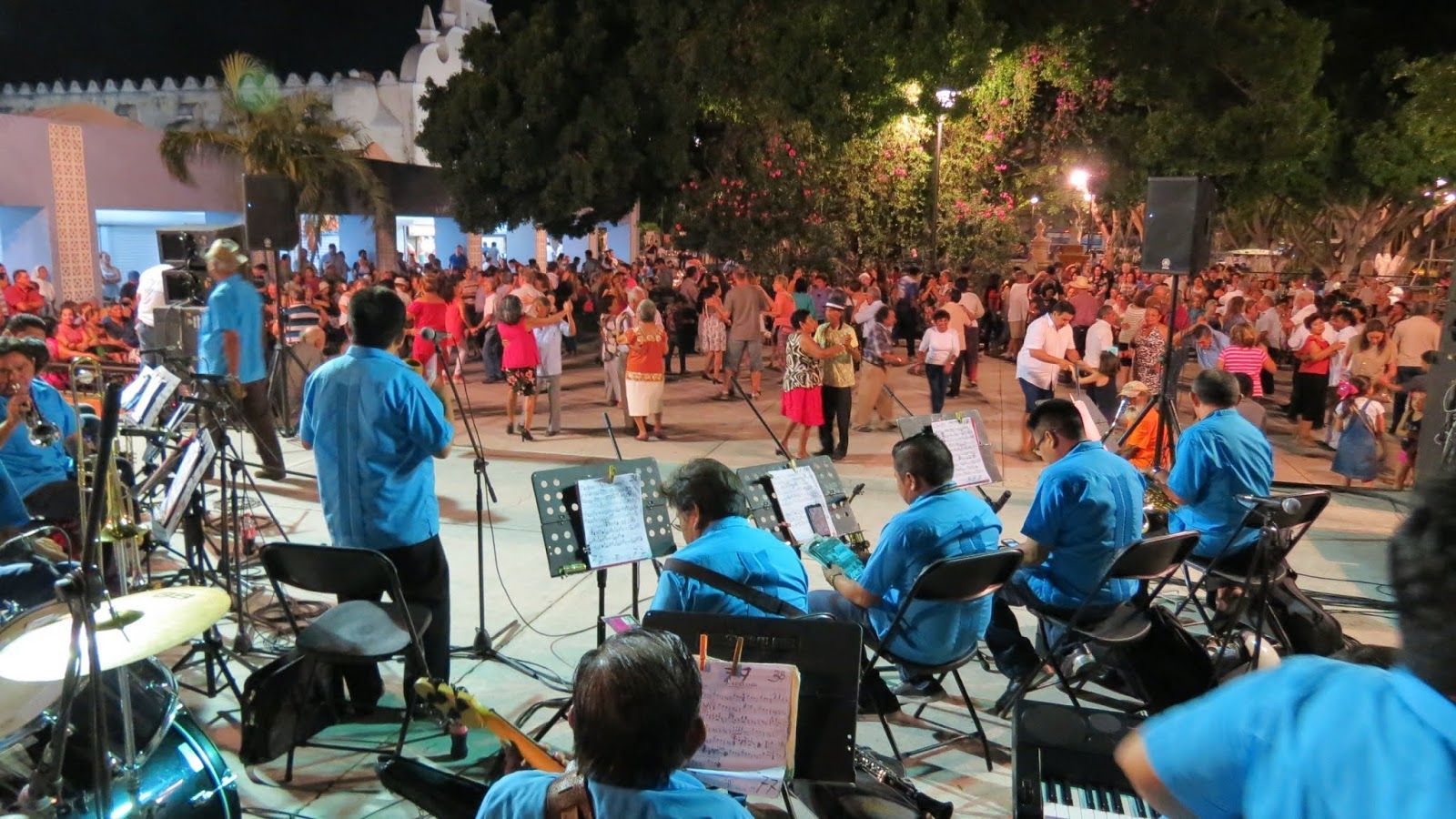 A band is playing in front of a crowd of people