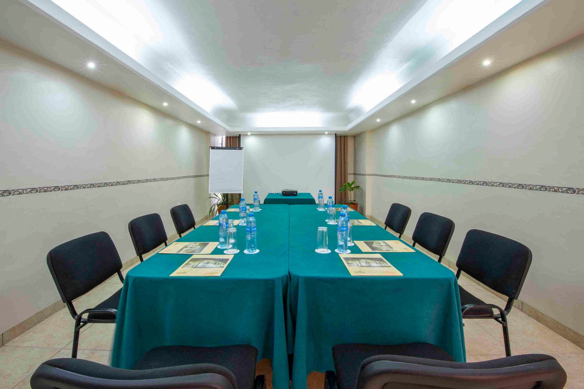 A conference room with a long table and chairs set up for a meeting.