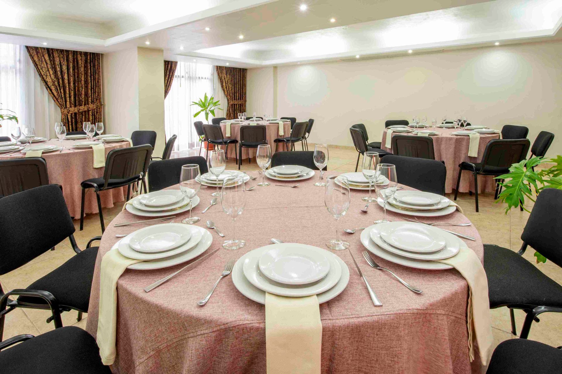 A large room with tables and chairs set up for a banquet.