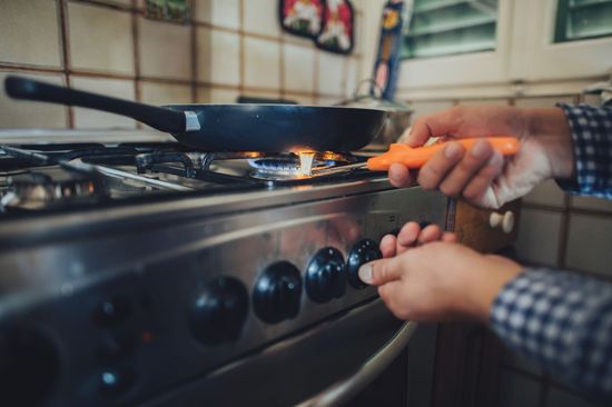 man switching stove