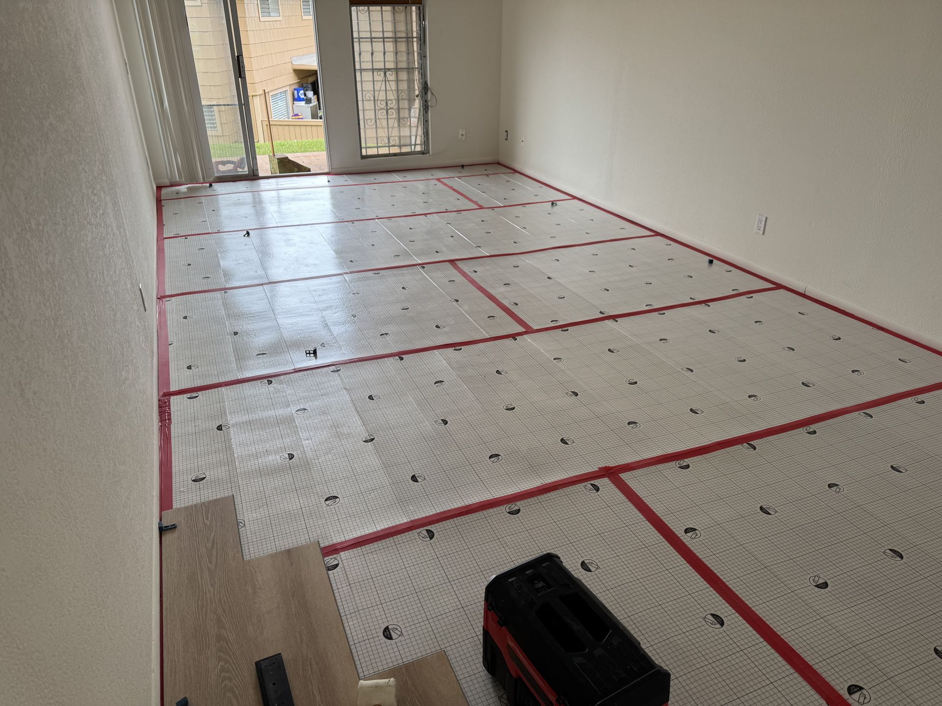 A person is laying a tile on the floor.