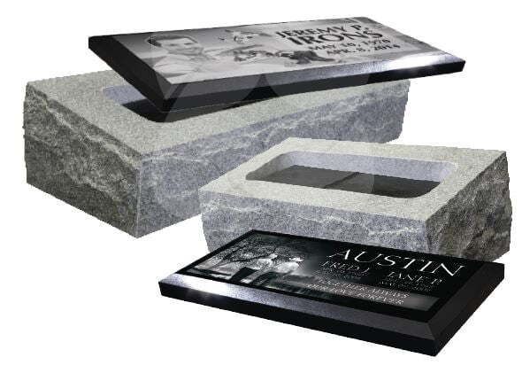 Two stone cemetery headstones with black polished plaques, one upright and one lying flat.