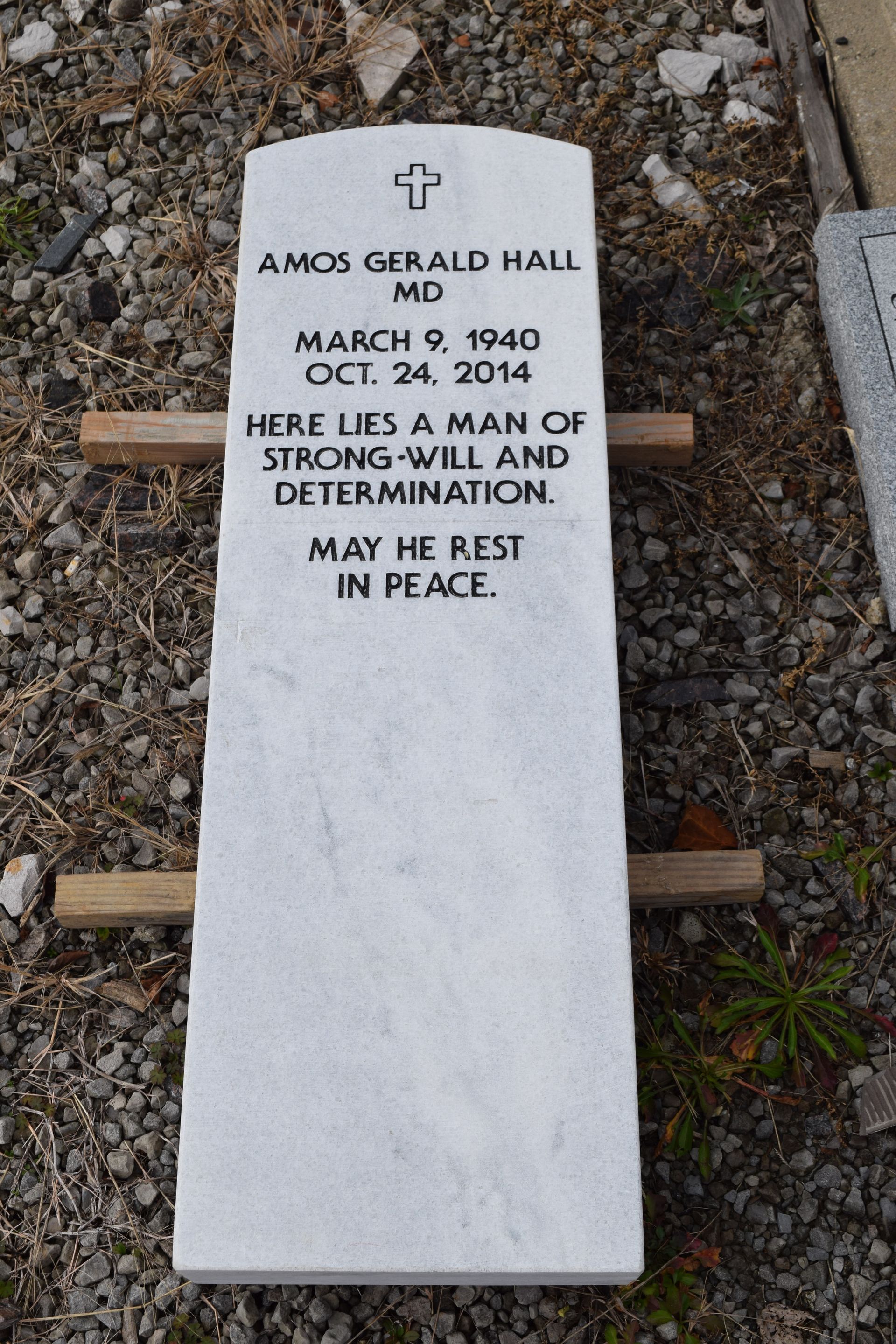 White memorial stone in gravel engraved for Amos Gerald Hall, March 9, 1940–Oct. 24, 2014, in St. Paul, Minn.