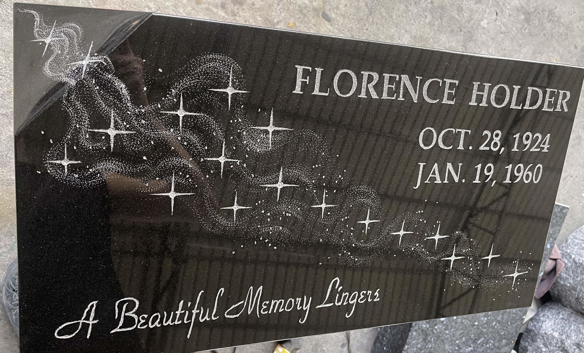 Gravestone for Florence Holder with etched flowers and the words “A Beautiful Memory Lives”