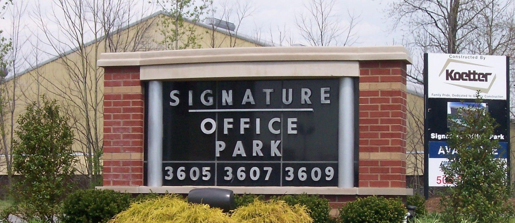 Sign at office park entrance reading “Signature Office Park,” with 3605, 3607, 3609, and a Knetter sign nearby