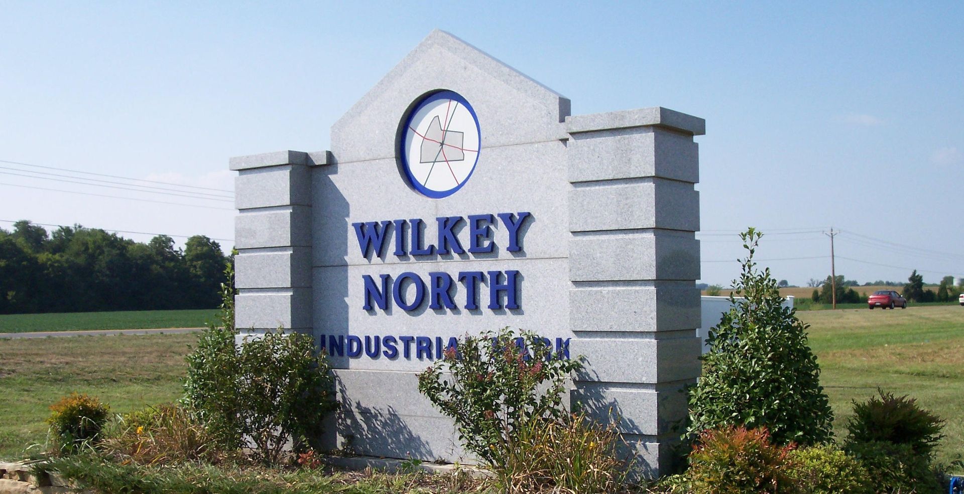 WILKEY NORTH INDUSTRIAL monument sign in a grassy field under a blue sky